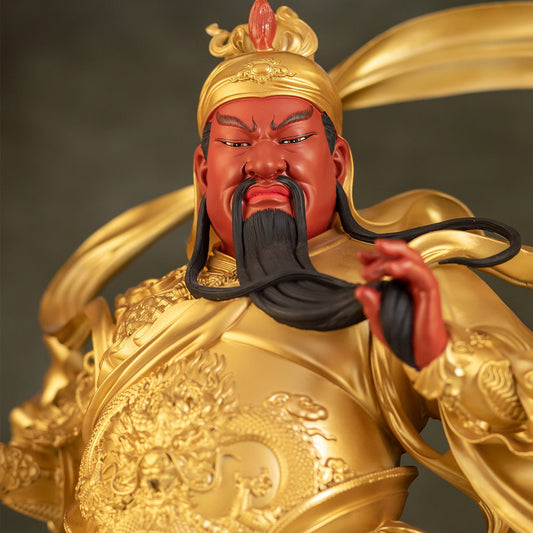 Close-up of Guan Gong statue, detailed red face and traditional helmet