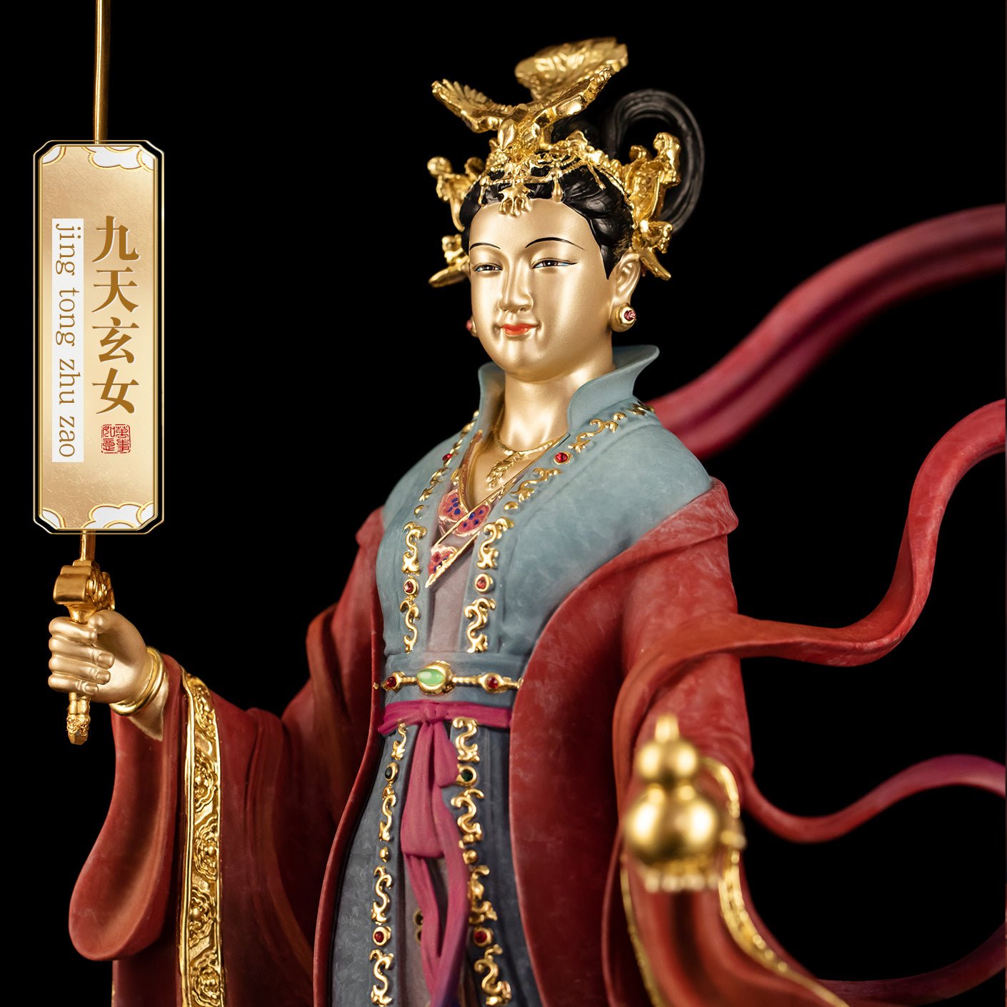 Close-up of brass Jiu Tian Xuan Nü statue, detailed face and headdress